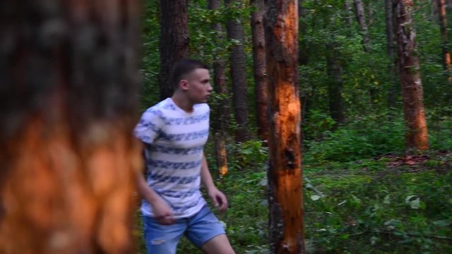 the guy scared, runs a summer forest
