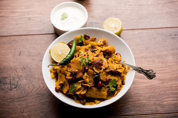 Homemade Kothu Parotta/ Paratha or Stir Fried Leftover Chapati Masala or  fodnichi poli in marathi, served in a bowl or plate with curd and hot tea. Selective focus