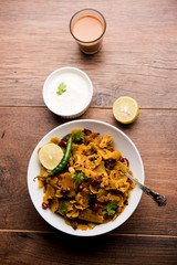 Homemade Kothu Parotta/ Paratha or Stir Fried Leftover Chapati Masala or  fodnichi poli in marathi, served in a bowl or plate with curd and hot tea. Selective focus