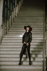 Young woman posing on the stairs.