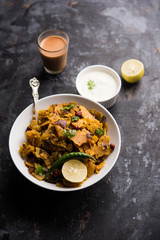 Homemade Kothu Parotta/ Paratha or Stir Fried Leftover Chapati Masala or  fodnichi poli in marathi, served in a bowl or plate with curd and hot tea. Selective focus