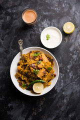 Homemade Kothu Parotta/ Paratha or Stir Fried Leftover Chapati Masala or  fodnichi poli in marathi, served in a bowl or plate with curd and hot tea. Selective focus