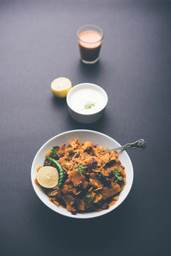 Homemade Kothu Parotta/ Paratha or Stir Fried Leftover Chapati Masala or  fodnichi poli in marathi, served in a bowl or plate with curd and hot tea. Selective focus