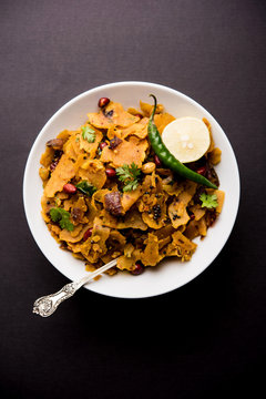 Homemade Kothu Parotta/ Paratha or Stir Fried Leftover Chapati Masala or  fodnichi poli in marathi, served in a bowl or plate with curd and hot tea. Selective focus