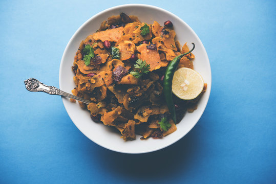 Homemade Kothu Parotta/ Paratha or Stir Fried Leftover Chapati Masala or  fodnichi poli in marathi, served in a bowl or plate with curd and hot tea. Selective focus