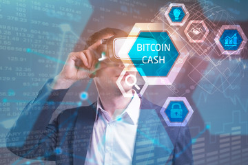 Obraz premium Business, Technology, Internet and network concept. Young businessman working in virtual reality glasses sees the inscription: bitcoin cash