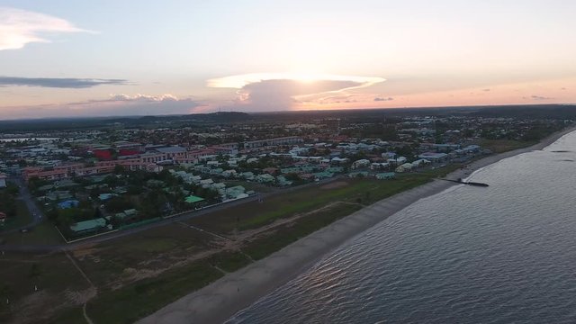 Sand football field along a beach on Kourou coastline. Aerial view sunset