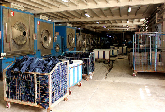 A Washing Machine With Washing Machines And Baskets Full Of Jeans