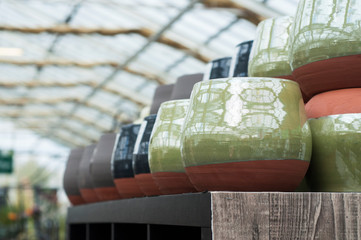 closeup of ceramic pots alignment in a gardening store