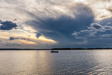 Fishing on a lake with over cast sunset.