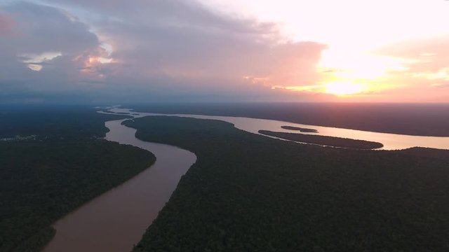 Drone shot over Mana river Guiana Suriname during sunset. Amazonian forest 