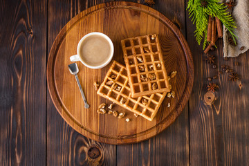 fresh belgian waffles, tasty jam and latte coffee on a wooden background. top view.