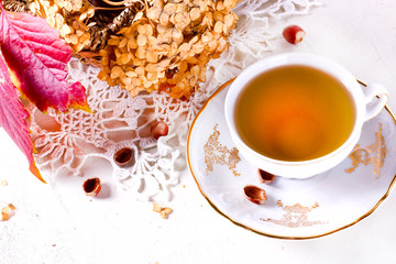 Tea in the rustic vintage Chic style. Garden tea Party. Teapot of dry flowers. Cup of tea with autumn decor on table, with hydrangea and pumpkin