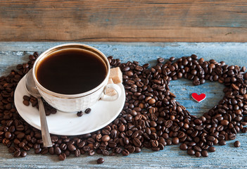 Coffee beans in heart shape on wood table