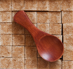 brown sugar heap and wooden spoon