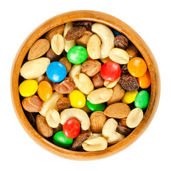 Trail mix in wooden bowl. Snack mix. Almonds, cashews, peanuts, hazelnuts, raisins and colorful...