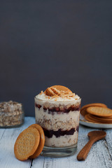 Oatmeal granula breakfast with cream in glass. Layered healthy food. Copy space.