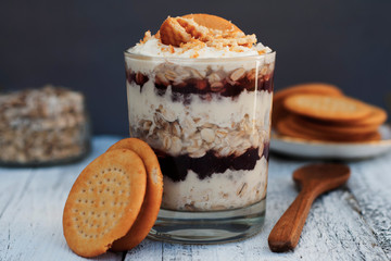 Oatmeal granula breakfast with cream in glass. Layered healthy food.