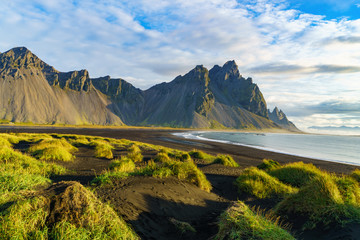 Vesturhorn Mountain in summer morning. Stokksnes, Iceland, Northern Europe, Scandinavia. Scenic beautiful nature landscape. Vibrant sunrise mountains landscape wallpaper. Popular tourist attraction.