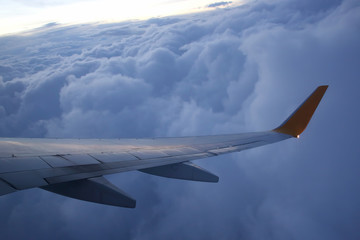 The wing of an airplane above the clouds