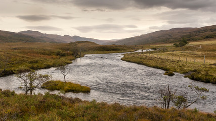 a river, mountains and clouds