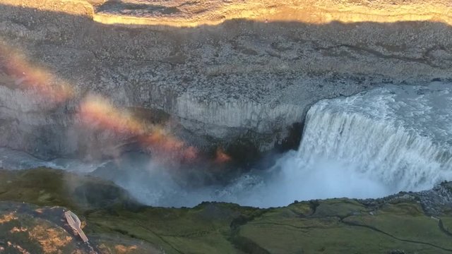 Slow motion aerial drone shot of Dettifoss reputed to be the most powerful waterfall in Europe. Located in Vatnaj&ouml;kull National Park in Northeast Iceland. Sunset time, beautiful rainbow