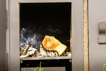Dark metal stove with wood burning