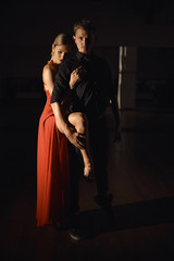 Fototapeta na wymiar Young beautiful couple dancing with passion