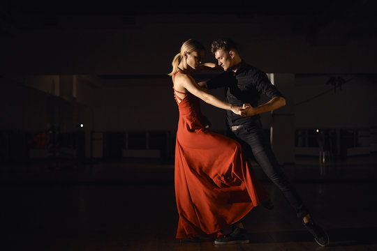 Young beautiful couple dancing with passion