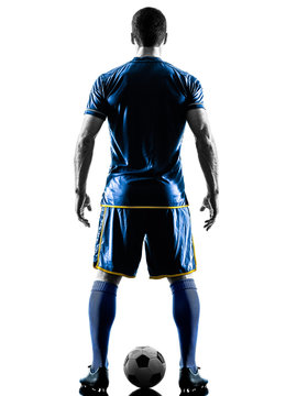 Fototapeta one caucasian soccer player man standing Rear View in silhouette isolated on white background