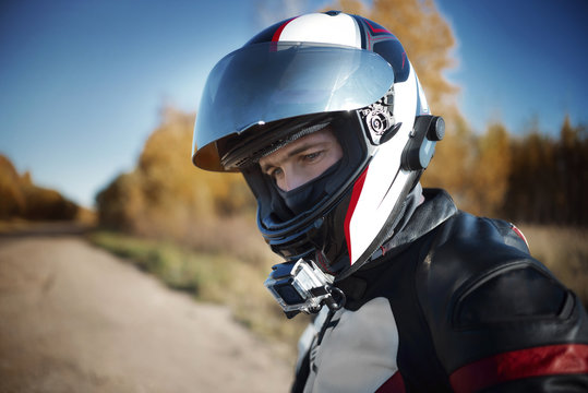 biker in a helmet looking away in nature