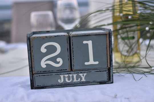 Wood blocks in box with date, day and month 21 July. Wooden blocks calendar