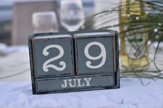 Wood blocks in box with date, day and month 29 July. Wooden blocks calendar
