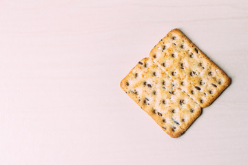 Full-grain biscuit with cereal on light background and space for text.