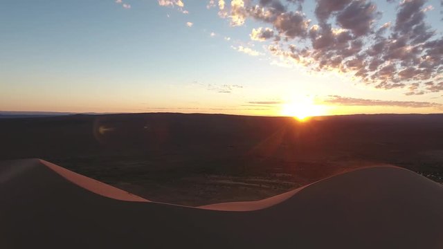 Aerial drone shot in gobi desert during sunrise zoom out sand dunes