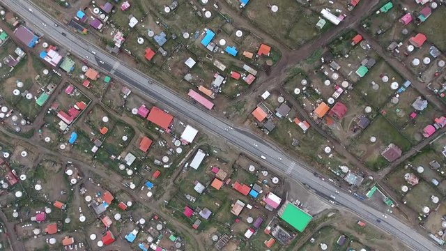 Aerial drone shot from top diagonal road in poor area Ulaanbaatar. 