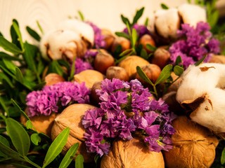 Obraz premium gift composition of nuts, cotton, flowers ( Statice (Limonium)) and pistachio leaves