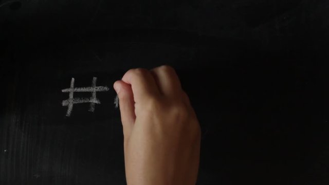 Woman hand writing Me too on blackboard