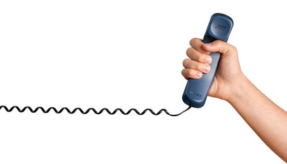 Hand Holding a Telephone Receiver