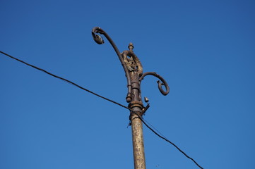 Forged top of an old lamppost.