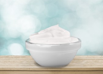 close up of a white beauty cream or yogurt on white background
