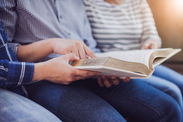 Christian friends group reading and study bible together in home or Sunday school at church with...