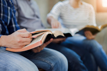 Christian friends group reading and study bible together in home or Sunday school at church with...