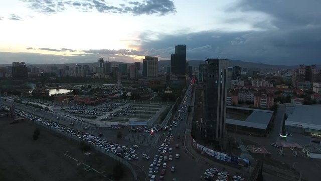 Beautiful sunset in Ulan bator traffic and buildings aerial drone shot