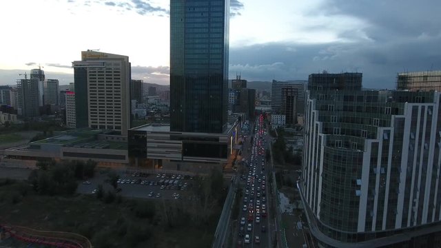 Beautiful sunset in Ulan bator traffic and buildings aerial drone shot big tower