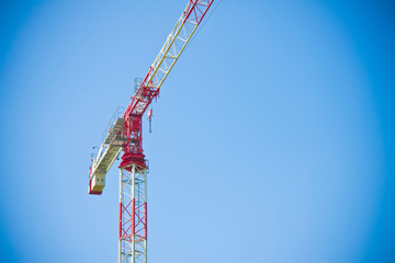 Tower crane in a blue background - image with copy space