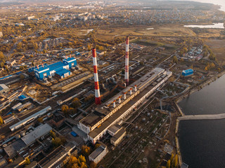 Aerial view of Voronezh Power Plant or station with high chimneys near water reservoir at sunset, drone photo