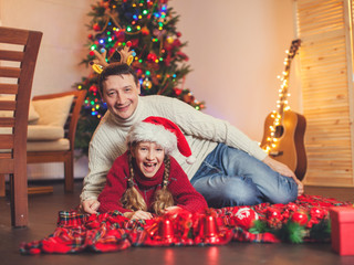 Smiling girl with dad near christmas tree at home