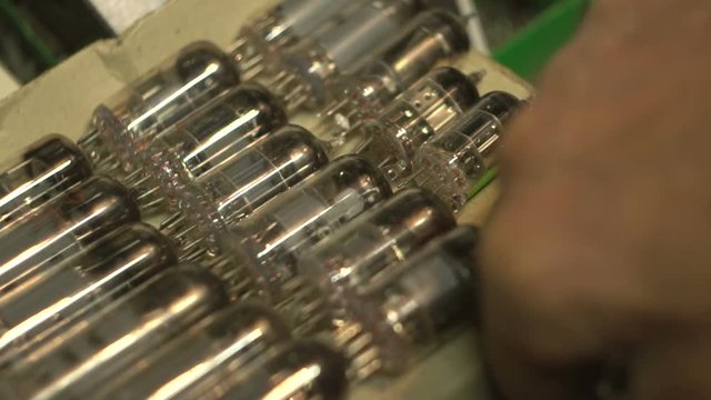 man makes up a series of vacuum tubes