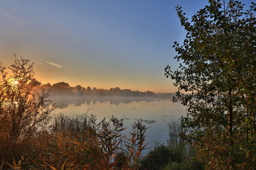 Early morning, sunrise over the lake. Rural landscape. HDR